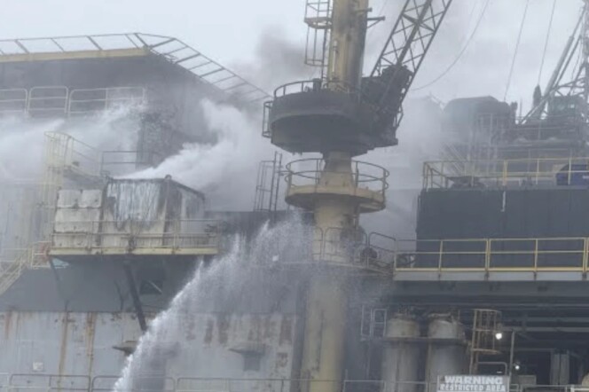 Smoke rises from an oil platform.