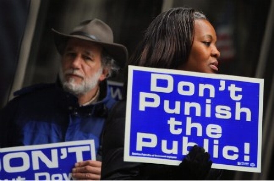 Federal Employees demonstrate outside the Ralph H. Metcalfe Federal Building on April 7, 2011 in Chicago, Illinois.