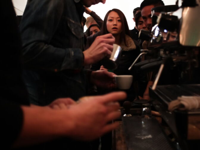 Spectators watch as latte artists compete.