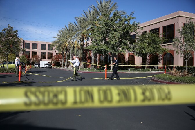 File: Officials put up police tape in front of the building at the Inland Regional Center were 14 people were killed on Dec. 7, 2015 in San Bernardino.