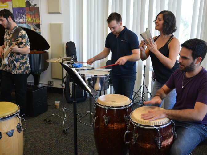 Members of the CalArts Salsa Band in rehearsal. (L-R): Josh Turner, bass; Carson Schafer, timbales; Emilia Moscoso, cowbell; Marcelo Bucater, congas.