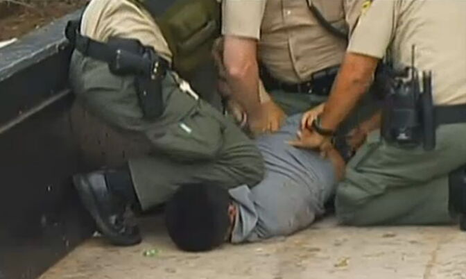 A screen shot from the video that captured the sheriff's deputy stomping on a suspect's head.
