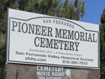 A sign that says "Pioneer Memorial Cemetery" in front of a cemetery