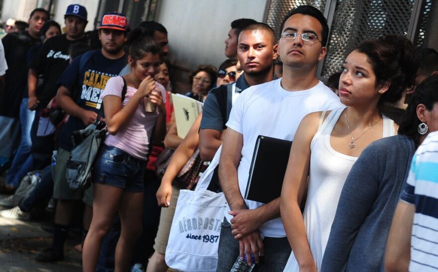 Young people wait in line to enter the office of The Coalition for Humane Immigrant Rights of Los Angeles (CHIRLA) on August 15, 2012 in Los Angeles, California, on the first day of the Deferred Action for Childhood Arrivals (DACA) program. US authorities began taking applications for deferred deportations from undocumented immigrants brought here as children, an initiative that could benefit up to 1.7 million people, as long lines of applicants, many who have long feared separation from their families and deportation from the country they've always considered home, formed outside consulates, advocacy offices and law firms. 
