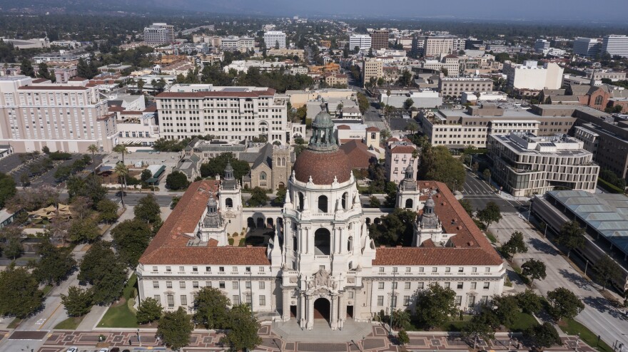 An overhead shot of a beautiful building that takes up an entire city block