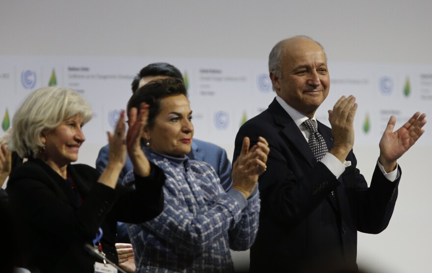 (L-R) French Ambassador for the international Climate Negotiations Responsible for COP21 Laurence Tubiana, Executive Secretary of the United Nations Framework Convention on Climate Change (UNFCCC) Christiana Figueres and Foreign Affairs Minister and President-designate of COP21 Laurent Fabius clap after adoption of a historic global warming pact at the COP21 Climate Conference in Le Bourget, north of Paris, on December 12, 2015. Envoys from 195 nations on December 12 adopted to cheers and tears a historic accord to stop global warming, which threatens humanity with rising seas and worsening droughts, floods and storms. AFP PHOTO / FRANCOIS GUILLOT / AFP / FRANCOIS GUILLOT        (Photo credit should read FRANCOIS GUILLOT/AFP/Getty Images)