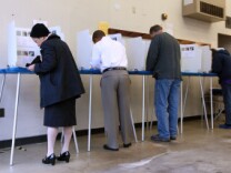 Voters fill out ballots at a polling place in a fire station on June 8, 2010 in Riverside, California.