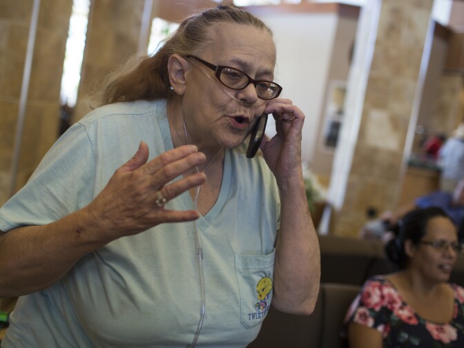 Doris Dodee anxiously awaits to be reunited with her 82-year-old husband, Glen Huffman, at a Red Cross evacuation center at the Jessie Turner Community Center on Wednesday afternoon, Aug. 17, 2016. Her husband flagged down a sheriff to help him get out of the area.