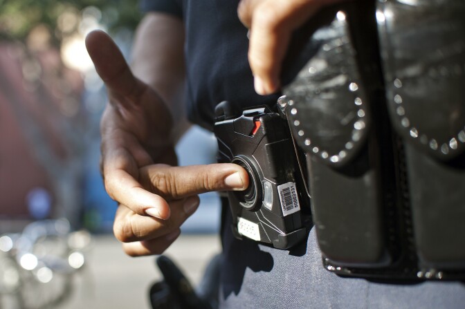 Officer Guillermo Espinoza pushes a button to turn his lapel camera on and off. The cameras don't roll for the entire shift, only when an officer presses record.