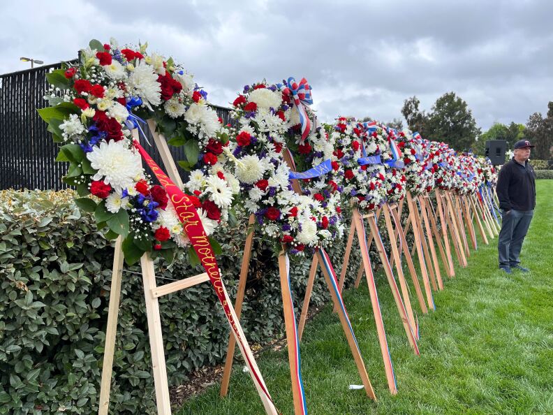 A row of floral wreaths, comprised of mostly white flowers.