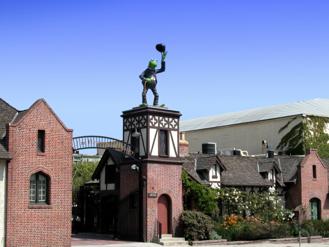 Kermit the Frog sit atop the entry gates to the Jim Henson Company studios.