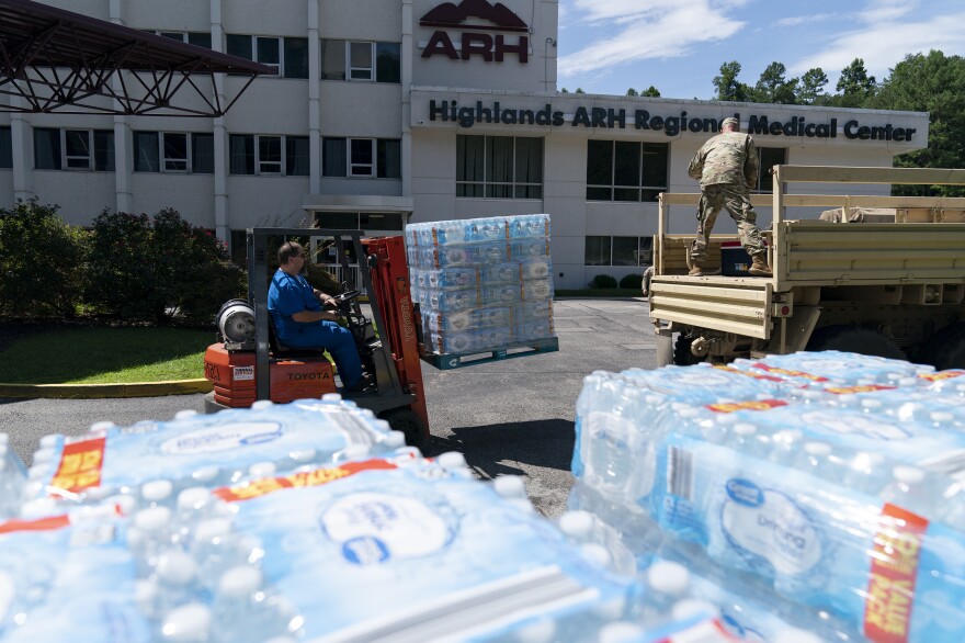 Employees of Highlands ARH Regional Medical Center load water bottles onto a Kentucky National Guard truck in front of the hospital in Prestonsburg on Thursday.