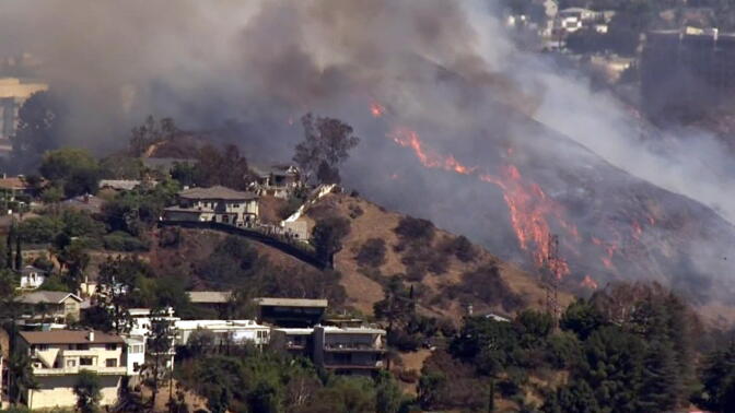 A brush fire burning near the 101 Freeway on Tuesday, July 19, 2016.