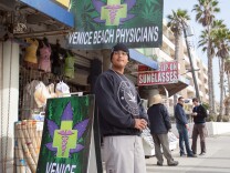 Michael Vides waits for potential patients outside of Venice Beach Physicians.