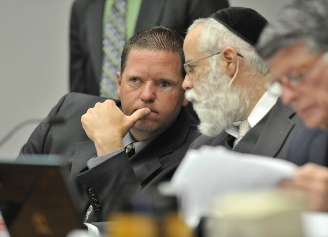 Now ex-Fullerton police officer Jay Cicinelli confers with his defense attorney, Michael D. Schwartz during a preliminary hearing for the death of Kelly Thomas, on May 7, 2012.