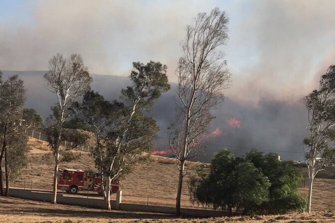The Liberty Fire started on Thursday afternoon and was holding at 300 acres Friday morning, with 60 percent containment. The fire destroyed at least one structure and six outbuildings, according to Murietta Fire and Rescue.