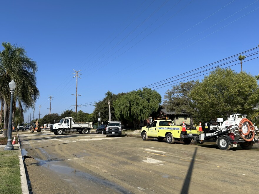 Three trucks on a wet road in Long Beach.