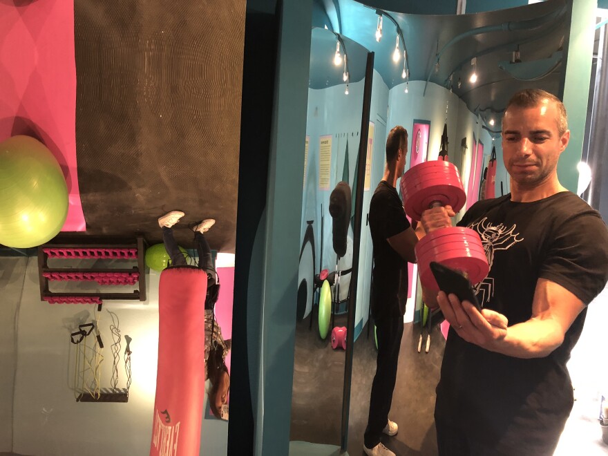 The gym room at the Museum of Selfies has fun house mirrors and weights that aren't quite as heavy as they appear.