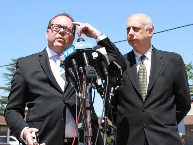 Attorney for the Arian family, Jeffrey Galen, points to his head to describe where a bullet entered Abdul Arian's skull. To the right of Galen is William Margolin, co-council.