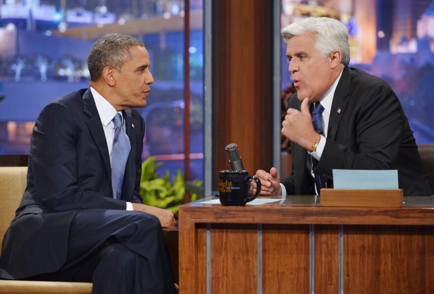 US President Barack Obama chats with host Jay Leno during a taping of The Tonight Show with Jay Leno at NBC Studios on August 6, 2013 in Burbank, California.  