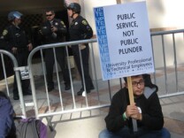 UCLA sociology major Adrian Corral protests outside a University of California Regents meeting at UCLA. Corral was among some 1,000 students and UC employees protesting on Wednesday a plan to increase student fees 32 percent. The University of California's full Board of Regents is expected to approve the fee hike tomorrow.