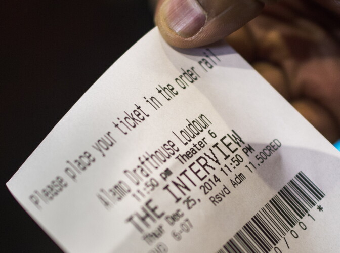 A man shows his ticket for "The Interview" purchased at the Alamo Drafthouse Cinema December 25, 2014 in Ashburn, Virginia.  