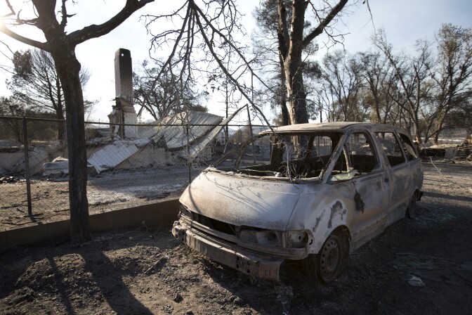 A chimney stack is all that remains a house, it’s burnt out vehicle outside. Both destroyed by the Blue Cut Fire in Phelan, California on August 18th, 2016.
