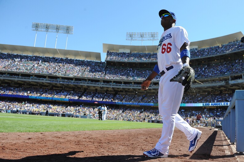 Yasiel Puig #66 of the Los Angeles Dodgers walks onto the field to start the game against the Colorado Rockies at Dodger Stadium on September 29, 2013 in Los Angeles, California.   