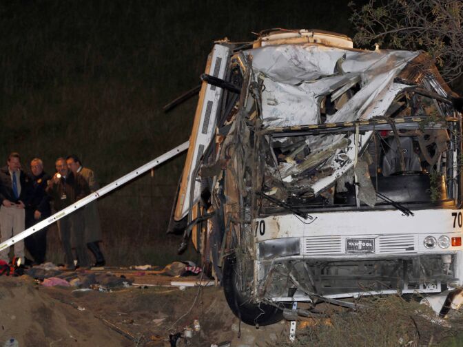 Investigators continue working the scene of a fatal tour bus crash near Yucaipa, Calif., Sunday, Feb. 3, 2013. (AP Photo/Nick Ut)