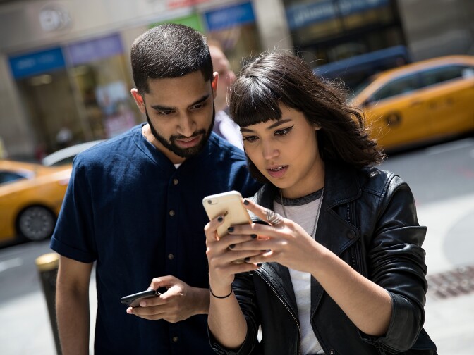 NEW YORK, NY - JULY 11: (L to R) Sameer Uddin and Michelle Macias play Pokemon Go on their smartphones outside of Nintendo's flagship store, July 11, 2016 in New York City.  The success of Nintendo's new smartphone game, Pokemon Go, has sent shares of Nintendo soaring. (Photo by Drew Angerer/Getty Images)