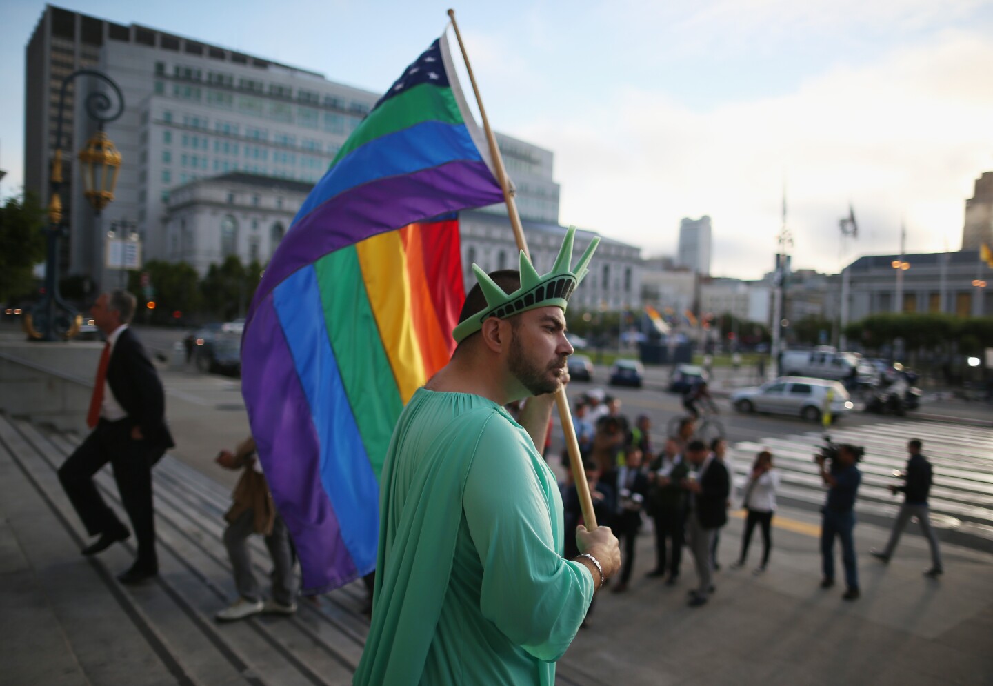 A gay rights supporter waves a flag at City Hall June 26, 2013 in San Francisco, United States. The high court will rule on DOMA and California's Prop 8. 