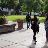 Cal State Fullerton students walk through the Quad on campus the morning after the campus was placed on lockdown when a robbery suspect was believed to have barricaded himself inside one of the buildings, Thursday, Dec. 13, 2012. Students return to class the day after.