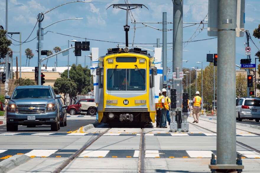 FILE: An Expo Line test train runs through downtown Santa Monica. The train is expected to open to the public in spring 2016.