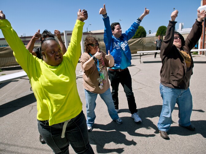 Jamesia Jones, left, rehearses a dance performance for "That's Not My Name" by the Ting Tings. Producers used tape to map out the dimensions of the James Armstrong Theater in the PASW parking lot.