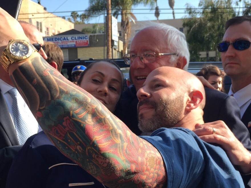 Fans pose with presidential candidate Bernie Sanders on Tuesday in L.A.'s Silver Lake neighborhood. 