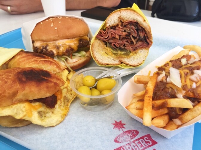 A breakfast sandwich, a burger, a pastrami sandwich and chili cheese fries at George's Burgers in Boyle Heights.