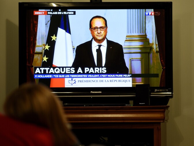 A person watches TV in Rennes as French president Francois Hollande adresses the nation on November 13, 2015 after a series of gun attacks occurred across Paris as well as explosions outside the national stadium where France was hosting Germany. Francois Hollande declared a state of emergency and closed borders . AFP PHOTO / DAMIEN MEYER        (Photo credit should read DAMIEN MEYER/AFP/Getty Images)