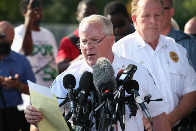 Standing in the parking lot of a gas station which was burned during rioting, Ferguson Police Chief Thomas Jackson announces the name of the Ferguson police officer responsible for the August 9, shooting death of teenager Michael Brown on August 15, 2014 in Ferguson, Missouri. The officer was identified as Darren Wilson, a six year veteran of the police department. Brown's killing sparked several days of violent protests in the city.