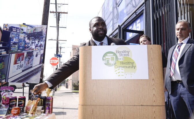 IMAGE DISTRIBUTED FOR HEALTHY STORES FOR A HEALTHY COMMUNITY - Public Health Director and Health Officer for the City of Pasadena Public Health Department Dr. Eric G. Walsh speaks at a press conference for the Healthy Stores for a Healthy Community campaign at the Euclid Market in Los Angeles on Wednesday, March 5, 2014. Four Southern California Health Departments released new data today on alcohol, tobacco, and junk food marketing to kids in stores available at www.healthystoreshealthycommunity.com. (Photo by Dan Steinberg/Invision for Healthy Stores for a Healthy Community /AP Images)