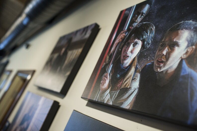 Artist Kyle Lambert created the "Stranger Things" poster and these paintings displayed on the walls of 21 Laps Entertainment.