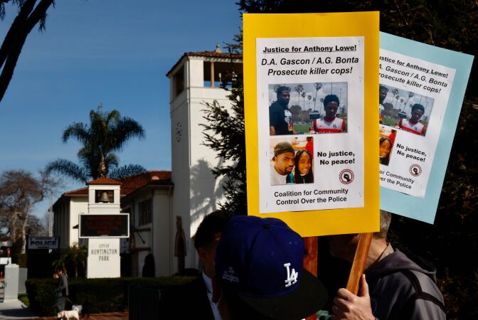 Protesters hold signs calling for justice for Anthony Lowe asking DA Gascòn and AG Bonta to "prosecute cop killers." Photos of Lowe are attached to colorful poster boards.