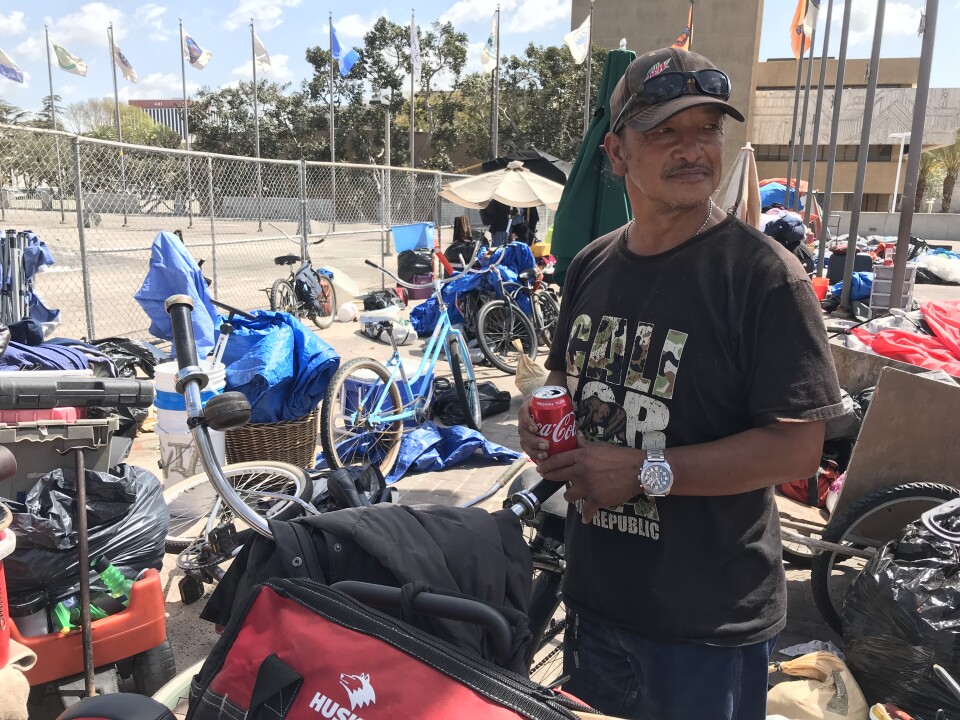 Bernard, 59, gets ready to leave the Plaza of the Flags, where he lived in a tent for eight years, bound for a homeless shelter in Anaheim. April 12, 2018. 
