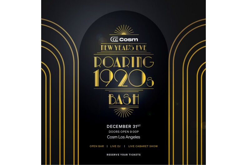 A promotional image for Cosm Los Angeles New Year's Eve Roaring 1920s Bash. The image has Art Deco black and gold design and font styling. A black image with concentric gold arches frame the left and right side of the image. In the center is the text, with white lettering for "December 31st. Doors Open 9:00 PM. Cosm Los Angeles. Open Bar. Live DJ. Live Cabaret Show. Reserve Your Tickets."