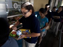 Kitty Chora, 8, gets lunch at Gratts Learning Academy for Young Scholars in Los Angeles. The Los Angeles Unified School District is starting a program that brings food produced within 200 miles of Los Angeles to area schools every Thursday.