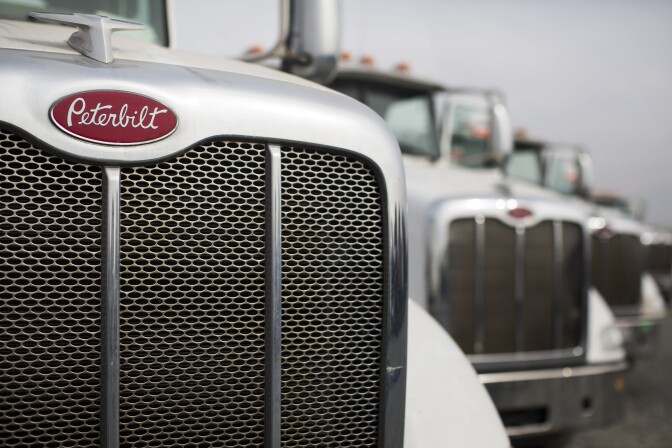 Peterbilt 384 liquefied natural gas trucks are in line to be auctioned off at Ritchie Bros. Auctioneers in Perris, Calif. on Friday, Dec. 9, 2016. 
