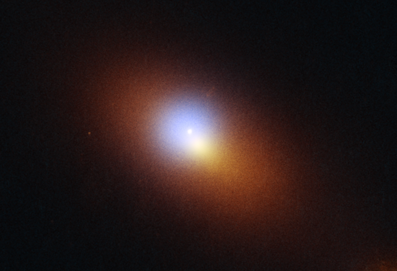 A bright orange light radiates from a bright white circle in a deep space. The image is grainy.