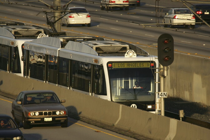 A Metrolink train carries passengers toward Los Angeles along the 210 freeway in Pasadena, California. 