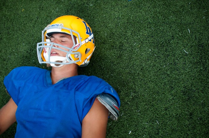 Kevin Dillman, 16, of La Mirada High School's Matadores varsity football team closes his eyes as he stretches on the field before practice in La Mirada, Wednesday, September 5, 2012. A native of Sweden, Dillman plans to pursue his dream into college football and later make it his career in the National Football League.