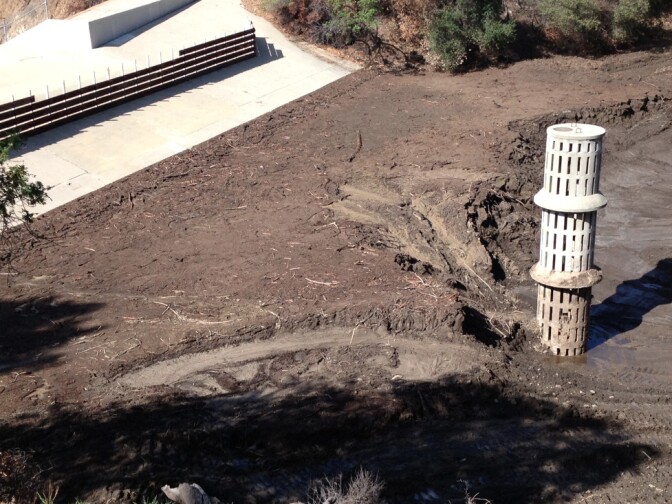 Several feet of mud from a recent rainstorm lies collected at the bottom of debris basin above Glendora, Calif.