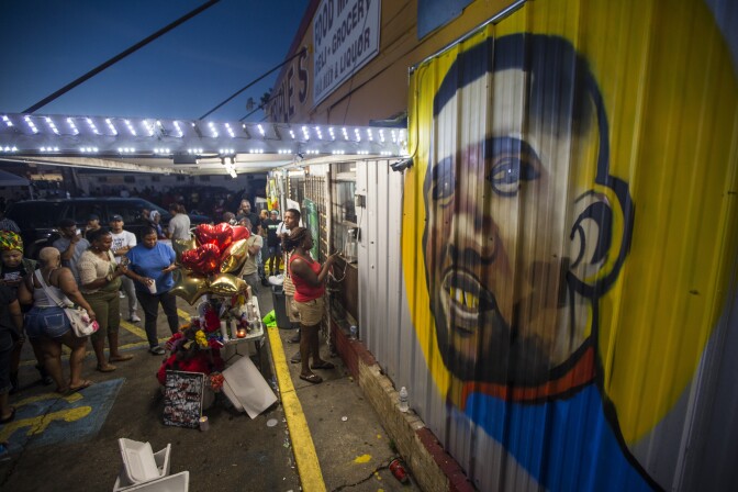 BATON ROUGE, LA -JULY 06:  protesters gather in front of a mural painted on the wall of the convenience store where Alton Sterling was shot and killed, July 6, 2016 in Baton Rouge, Louisiana.  Sterling was shot by a police officer in front of the Triple S Food Mart in Baton Rouge on Tuesday, July 5, leading the Department of Justice to open a civil rights investigation. (Photo by Mark Wallheiser/Getty Images)